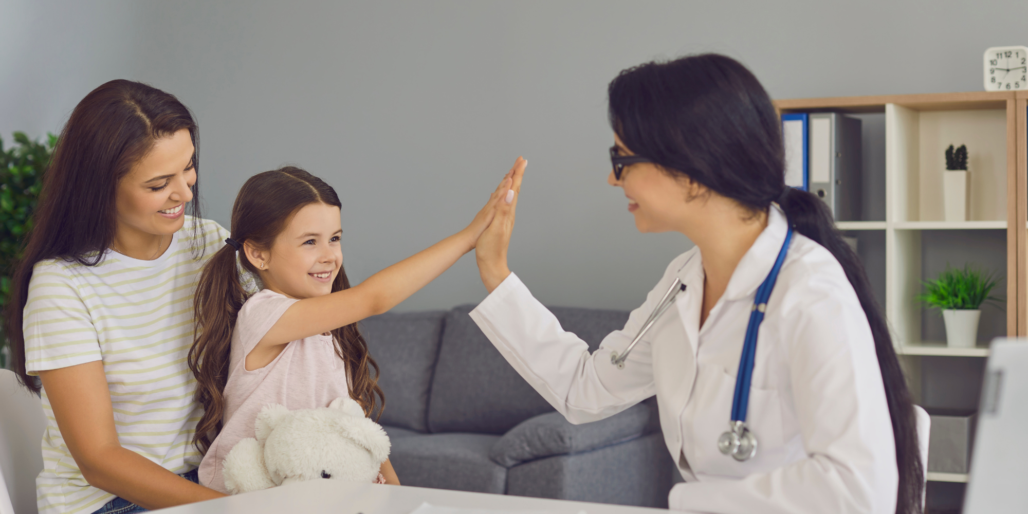 Kid giving a high five to a doctor